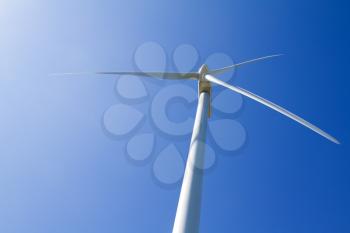 A wind turbine under clear blue sky