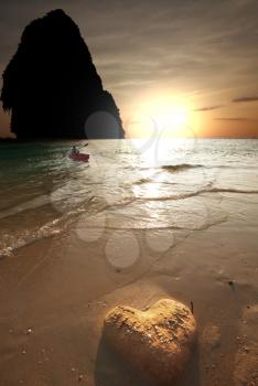 Royalty Free Photo of a Boat in the Adaman Sea in Thailand at Sunset