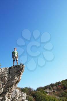 Royalty Free Photo of a Boy on a Cliff