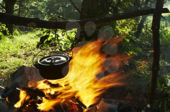Royalty Free Photo of a Kettle Over a Campfire