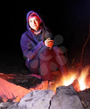 Royalty Free Photo of a Woman Sitting at a Campfire