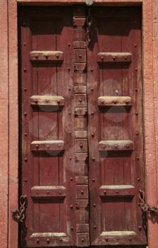 Royalty Free Photo of a Red Wood Door in Taj Mahal Palace
