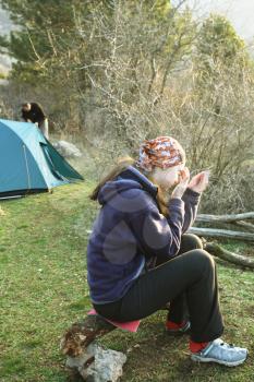 Royalty Free Photo of a Woman Sitting by a Tent