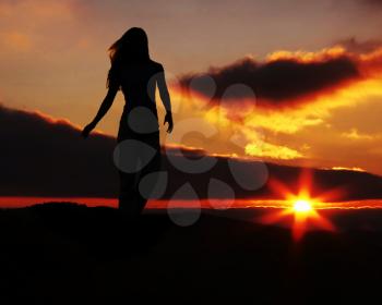 Royalty Free Photo of a Silhouette of a Woman at Sunset