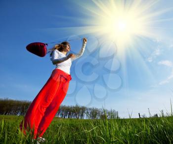 Royalty Free Photo of a Woman in a Field Holding a Balloon