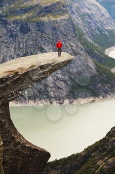 Royalty Free Photo of a Man Standing on a cliff