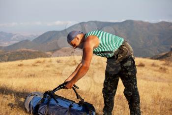 Royalty Free Photo of a Man Adjusting His Backpack