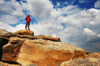 Royalty Free Photo of a Backpacker Standing on a Rock