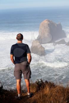 Royalty Free Photo of a Man Looking at the Ocean