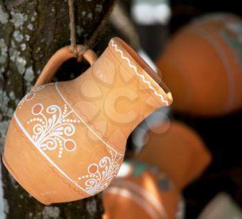 Royalty Free Photo of a Ceramic Pot Hanging From a Tree
