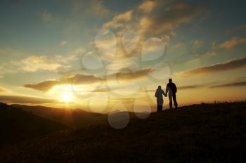 Royalty Free Photo of a Silhouette of a Couple Watching a Sunset