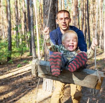 Laughing boy on swing