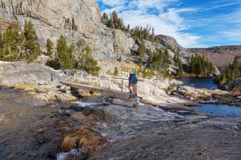 Man with hiking equipment walking in Sierra Nevada mountains, California, USA