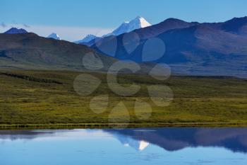 Picturesque Mountains of Alaska in summer. Snow covered massifs, glaciers and rocky peaks.