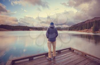 Man on mountains lake in autumn season. Colorado, USA