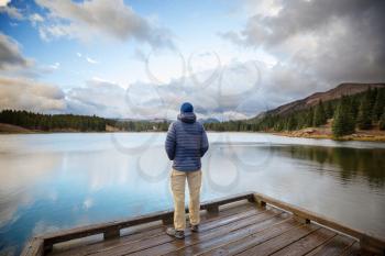 Man on mountains lake in autumn season. Colorado, USA