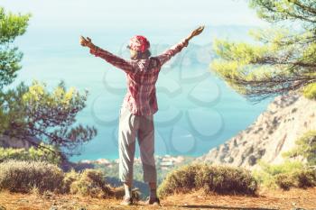 Happy girl on the cliff on sea coast