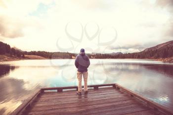 Hiker relaxing at serene mountain lake