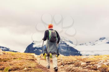 Hiking man in Canadian mountains. Hike is the popular recreation activity in North America. There are a lot of picturesque trails.