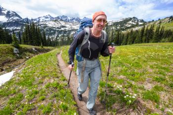 Backpacker in a hike in the summer mountains