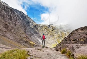 Backpacker in hike in the high mountains