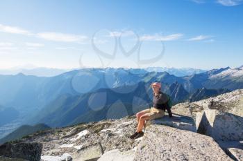 Man in a hike in the summer mountains. Beautiful natural landscapes.