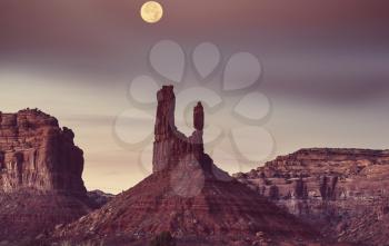 Valley of the Gods rock formation with Monument Valley at sunrise