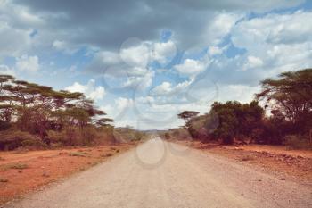 Safari and extreme travel in Africa. Drought  mountain landscape with dust off road in offroad car expedition.