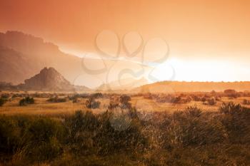 Summer rain in the mountains. Dramatic clouds and mountains silhouette.