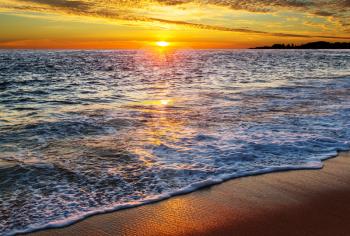 Beautiful sandy beach at sunrise for vacation background.