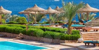 beach umbrellas by the pool. Vacation concept