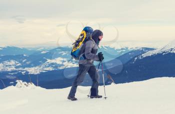 Hiker with snowshoes in winter