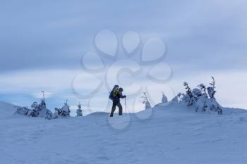 Hiker with snowshoes in winter