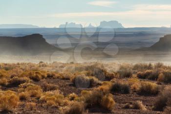 Valley of the Gods rock formation with Monument Valley at sunrise