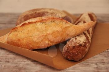Different breads on wooden table. Food background