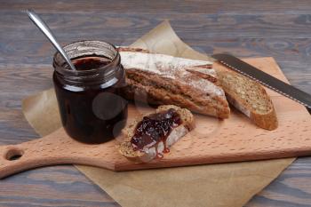 Bread and jam on wooden background