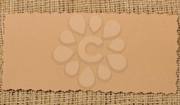 Old paper tag on natural burlap