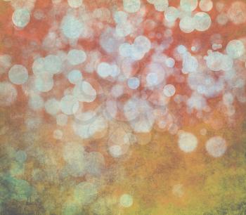 Glowing bokeh effects on a textured paper background