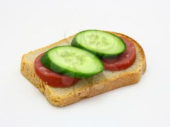 Healthy sandwich with sausage and a cucumber on a white background