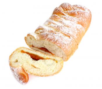 The rich ruddy roll is strewed by powdered sugar with a stuffing from dried apricots on a white background