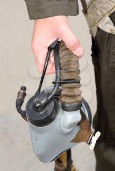 Uniforms, oxygen mask in his hand a military pilot in green overalls