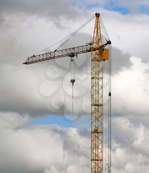 yellow crane and blue sky on building site