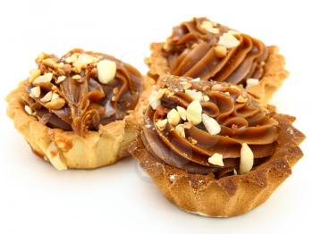 Pie a basket with chocolate condensed milk and nuts on a white background