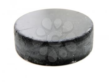 Black old hockey puck isolated on white background
