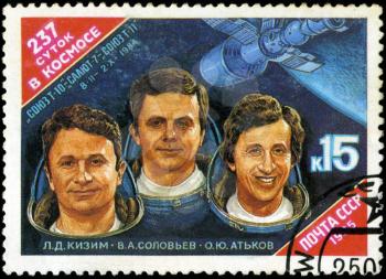 USSR - CIRCA 1985: stamp printed in USSR, shows portraits Cosmonauts L. Kizim, V. Soloviov, O. Atkov and Spacecraft Salyut-7, circa 1985
