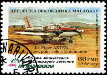 REPUBLICA MALAGASY - CIRCA 1987: A stamp printed in Malagasy (Madagascar) shows plane Aztec, circa 1987