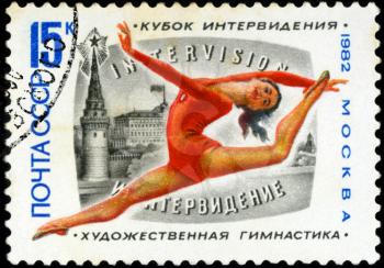 USSR - CIRCA 1982: A stamp printed in USSR shows woman on balance beam, devoted world championship on gymnastics in Moscow, circa 1982