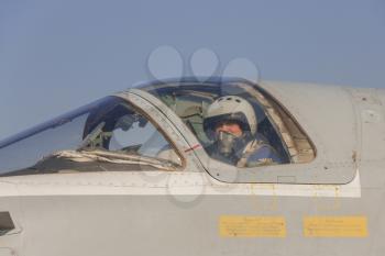 Military pilot in the cockpit of a jet aircraft.