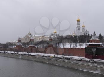 View of the Kremlin Embankment and cathedrals in Moscow, Russia at wintertime during snowfall