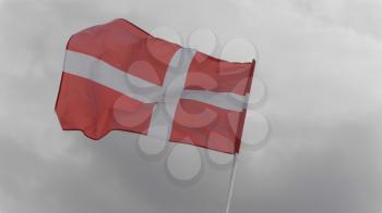 Denmark flag on the flagpole waving in the wind against a blue sky with clouds. Slow motion.